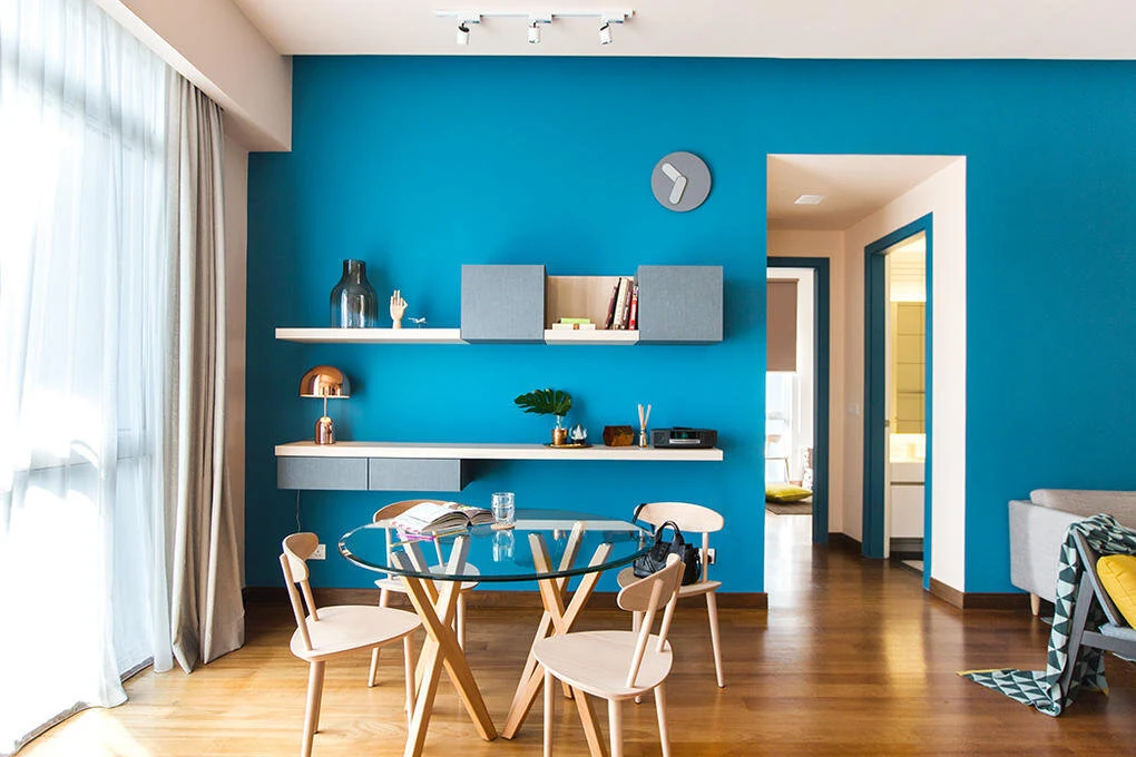 Bright teal dining room with freshly colored walls and natural light